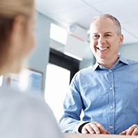 Smiling man at front desk