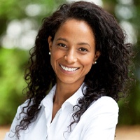 smiling woman wearing a white collared shirt