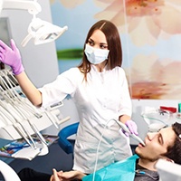 A dentist showing examining a patient.