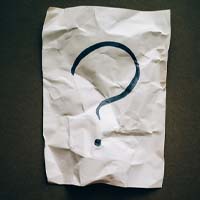 Question mark on wrinkled white paper