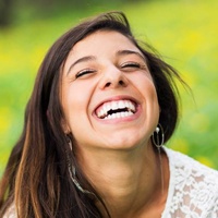Laughing woman with beautiful smile outdoors