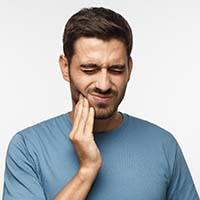 Man with toothache needs to visit his Bellevue emergency dentist