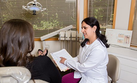 Dr. Taneja showing patient paperwork