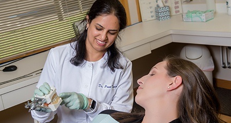 Dr. Taneja showing patient smile model