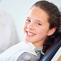 Smiling young girl in dental chair
