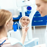 Cosmetic dentist in Bellevue smiling at a patient