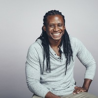 person sitting down and smiling